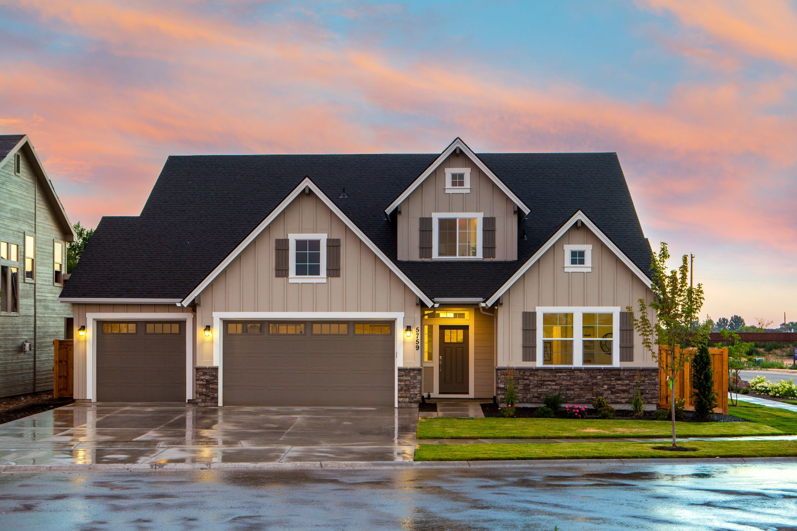 Craftsman home at dusk with a clean, kept front yard